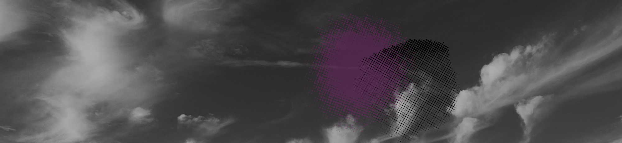 Black-and-white photograph of cloudy sky with a small purple lens flare.