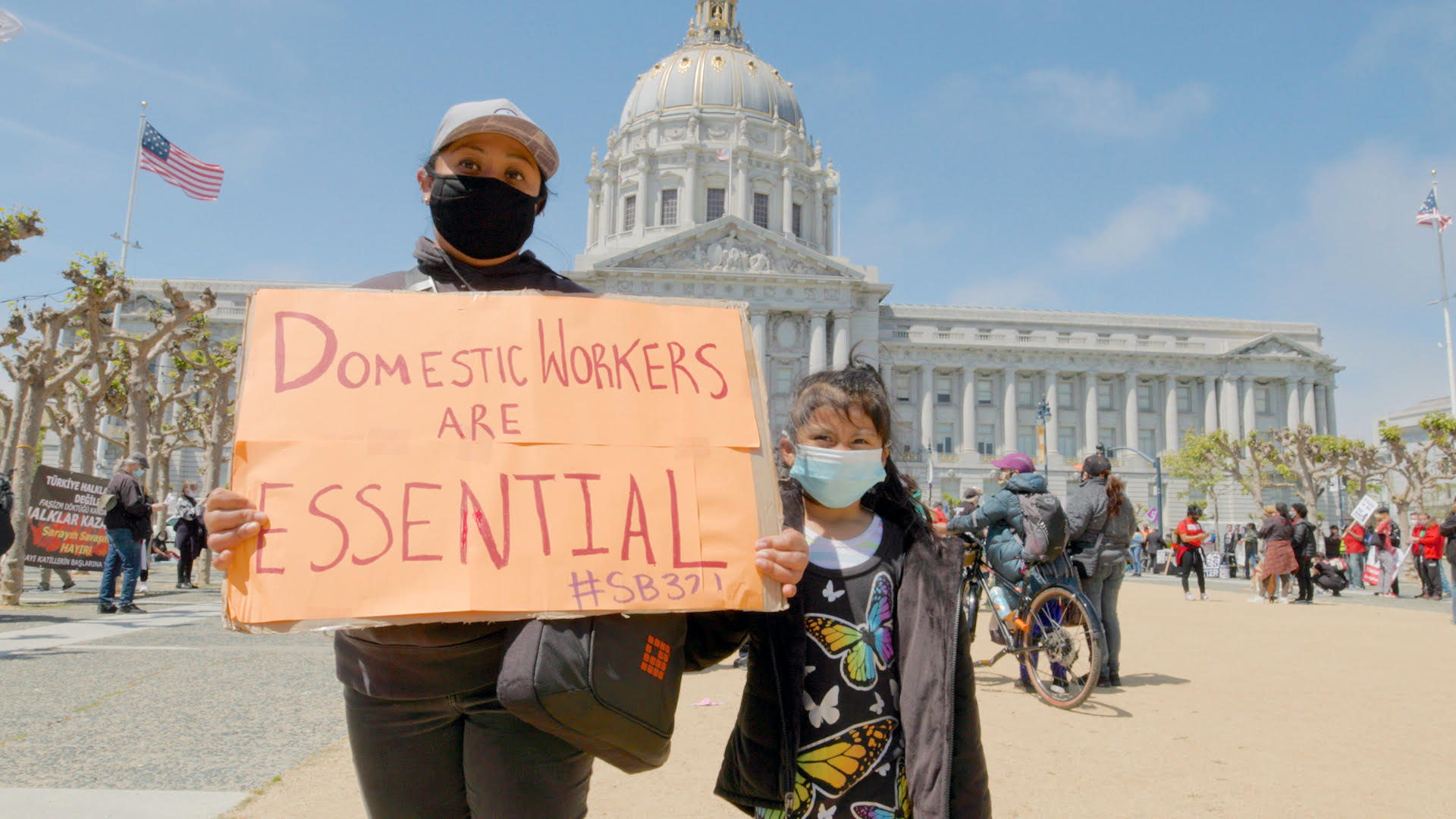 Domestic worker and child protesting