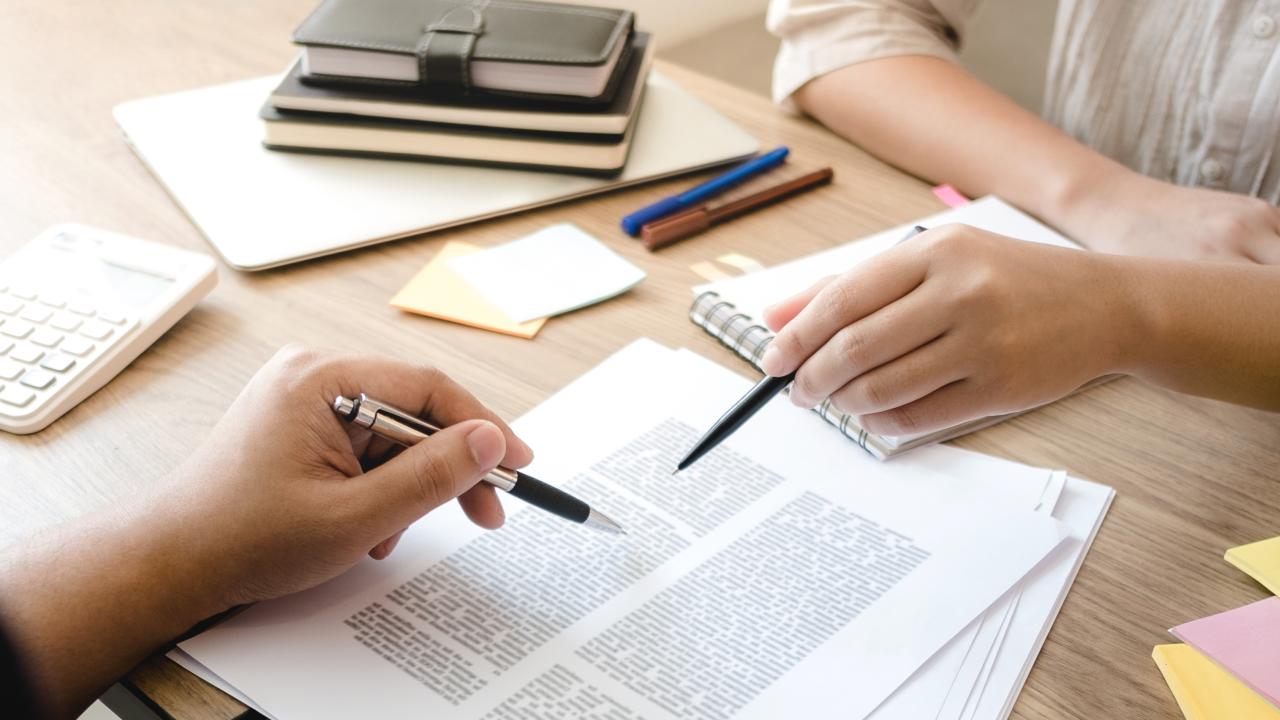 Two people collaborating on a paper