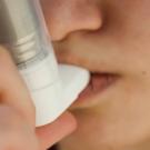 Teen with asthma using an inhaler